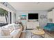 Bright living room with comfortable seating, stylish decor, and a large window offering scenic views at 1555 Tarpon Center Dr # G 235, Venice, FL 34285