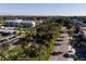 Aerial view showcasing a community street lined with palm trees and well-maintained landscaping at 1555 Tarpon Center Dr # G 235, Venice, FL 34285