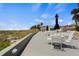 Relaxing outdoor seating area with tables, umbrellas and beach views on a sunny day at 1555 Tarpon Center Dr # G 235, Venice, FL 34285
