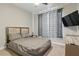 Well-appointed bedroom with neutral colors, a cozy bed, and a wall-mounted TV at 15963 Crofton Springs Way, Port Charlotte, FL 33953