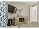 Modern bedroom boasts built in fireplace, TV, and large mirror at 15963 Crofton Springs Way, Port Charlotte, FL 33953