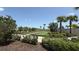Bocce ball courts surrounded by palm trees and lush landscaping, perfect for outdoor recreation at 15963 Crofton Springs Way, Port Charlotte, FL 33953
