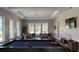 Well-lit game room featuring a pool table, seating areas, and bright windows at 15963 Crofton Springs Way, Port Charlotte, FL 33953
