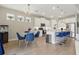 Open floor plan features the kitchen with white cabinets, stainless steel appliances, island, breakfast bar, and dining area at 15963 Crofton Springs Way, Port Charlotte, FL 33953
