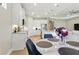 Open floor plan kitchen with white cabinets, stainless steel appliances, marble countertop island, and pendant lighting at 15963 Crofton Springs Way, Port Charlotte, FL 33953