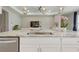 Open concept kitchen with white cabinets, granite counters, stainless steel appliances, and center island at 15963 Crofton Springs Way, Port Charlotte, FL 33953
