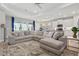 Spacious living room with a large sectional couch, bright windows and an open floor plan with the kitchen at 15963 Crofton Springs Way, Port Charlotte, FL 33953
