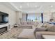 Spacious living room with a large sectional couch, bright windows and an adjacent kitchen area at 15963 Crofton Springs Way, Port Charlotte, FL 33953