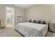 Comfortable main bedroom showcasing neutral tones and large windows at 15963 Crofton Springs Way, Port Charlotte, FL 33953