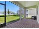 The screened patio has brick pavers overlooking a green backyard at 15963 Crofton Springs Way, Port Charlotte, FL 33953