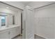 Primary bathroom showcasing dual sinks, a walk-in closet and a tiled shower at 17595 Opal Sand Dr # 205, Venice, FL 34293