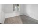 A bright bedroom featuring fresh gray carpet, a window, and white walls at 17595 Opal Sand Dr # 205, Venice, FL 34293