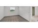 A bright bedroom featuring fresh gray carpet, a window, and sliding glass doors at 17595 Opal Sand Dr # 205, Venice, FL 34293