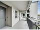Exterior hallway featuring sleek railings and apartment doors, with an open-air design at 17595 Opal Sand Dr # 205, Venice, FL 34293