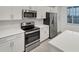 Modern kitchen features stainless steel appliances, and white countertops, creating a bright space at 17595 Opal Sand Dr # 205, Venice, FL 34293