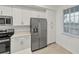Well-equipped kitchen features stainless steel appliances, white cabinetry, and light quartz countertops at 17595 Opal Sand Dr # 205, Venice, FL 34293