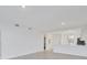 Open living space with large windows and bright walls leading to the kitchen at 17595 Opal Sand Dr # 205, Venice, FL 34293