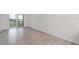 A bright living room featuring an outdoor view and light gray tile flooring at 17595 Opal Sand Dr # 205, Venice, FL 34293