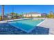 Community pool with wheelchair lift, surrounded by modern paving at 17595 Opal Sand Dr # 205, Venice, FL 34293