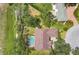 Aerial view of a home showcasing the large lot, screened-in pool, and lush landscaping at 188 Grand Oak Cir, Venice, FL 34292