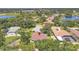 Aerial view of a home nestled among lush trees in a well-established neighborhood at 188 Grand Oak Cir, Venice, FL 34292