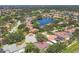 Residential aerial view featuring a central lake with fountain, well-maintained homes, and lush landscaping at 188 Grand Oak Cir, Venice, FL 34292