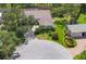 Aerial view of home and property with mature trees, and circular driveway in a cul-de-sac at 188 Grand Oak Cir, Venice, FL 34292