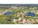 Aerial view showcasing a residential area with lakes, lush landscaping and neighborhood amenities at 188 Grand Oak Cir, Venice, FL 34292