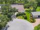 Aerial view of a home highlighting the lush landscaping, circular drive, and private lot at 188 Grand Oak Cir, Venice, FL 34292