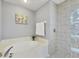 Bright bathroom featuring a tub and glass-enclosed shower at 188 Grand Oak Cir, Venice, FL 34292