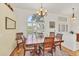 Elegant dining room featuring a wood table and chairs with large arched window and plantation shutters at 188 Grand Oak Cir, Venice, FL 34292