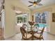 Bright breakfast nook with a glass table and views of the pool and outdoor area at 188 Grand Oak Cir, Venice, FL 34292