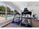 Community fitness center featuring treadmills and pool views at 188 Grand Oak Cir, Venice, FL 34292