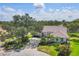 Well-manicured home featuring a tile roof, lovely landscaping, and a circular driveway at 188 Grand Oak Cir, Venice, FL 34292