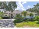 Well-maintained single-story home featuring mature landscaping, a tile roof, and a welcoming entrance at 188 Grand Oak Cir, Venice, FL 34292