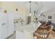 Bright kitchen featuring white cabinets, countertops, and bar seating with pendant lighting at 188 Grand Oak Cir, Venice, FL 34292