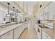 Well-lit kitchen with a long countertop, white appliances, and tile flooring for easy cleaning at 188 Grand Oak Cir, Venice, FL 34292