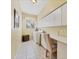 Laundry room including a desk and overhead storage at 188 Grand Oak Cir, Venice, FL 34292