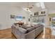 Spacious living room with high ceilings, a ceiling fan, and sliding doors to the pool area at 188 Grand Oak Cir, Venice, FL 34292