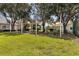 Outdoor picnic area with shaded tables and lush green surroundings at 188 Grand Oak Cir, Venice, FL 34292
