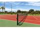 Community tennis court with well-maintained net and scenic surroundings at 188 Grand Oak Cir, Venice, FL 34292