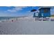 Picturesque beach scene with blue lifeguard tower and sunbathers at 200 The Esplanade N # C19, Venice, FL 34285