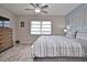 Bright bedroom featuring a comfortable bed, complemented by soft lighting and tasteful decor at 200 The Esplanade N # C19, Venice, FL 34285