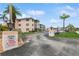 Lovely exterior of a multi-Gathering dwelling with palm trees and neatly manicured grounds on a sunny day at 200 The Esplanade N # C19, Venice, FL 34285