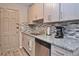 Cozy kitchen features stainless steel appliances, granite countertops, stylish backsplash, and shaker cabinets at 200 The Esplanade N # C19, Venice, FL 34285