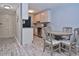 Open kitchen and dining space featuring stainless steel appliances, granite countertops, and shaker cabinets at 200 The Esplanade N # C19, Venice, FL 34285