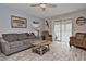 Inviting living room with wood floors, cozy seating, and a sliding door to an enclosed porch at 200 The Esplanade N # C19, Venice, FL 34285