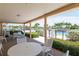 Relaxing covered patio area with comfortable seating, overlooking the lush landscaping and the nearby pool at 200 The Esplanade N # C19, Venice, FL 34285
