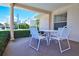 Relaxing patio with outdoor seating and beautiful views of the surrounding landscape and blue sky at 200 The Esplanade N # C19, Venice, FL 34285