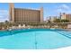 Large, inviting pool with plenty of lounge chairs for relaxing and enjoying the surrounding buildings at 200 The Esplanade N # C19, Venice, FL 34285